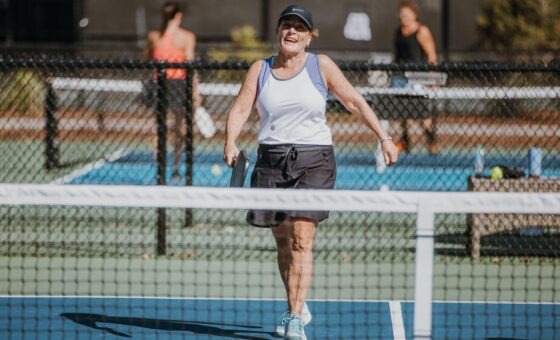 Woman happy playing pickleball Roy Barth Tennis Center